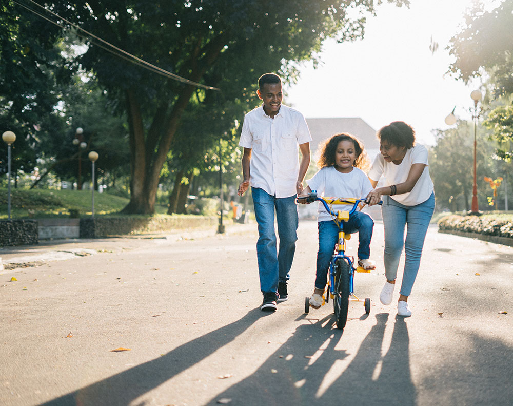man-standing-beside-his-wife-teaching-their-child-how-to-1128318 (1)