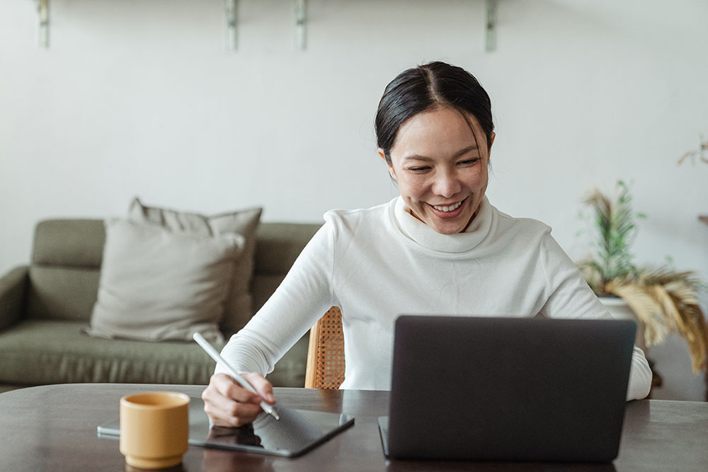 woman-working-at-home-and-making-video-call-on-laptop
